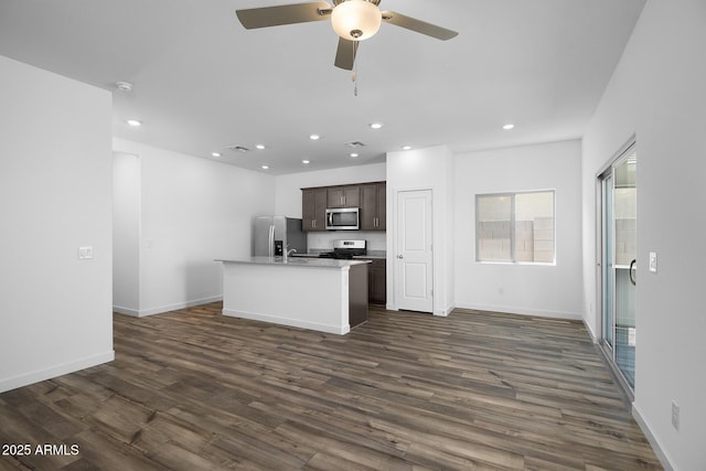 24593 W St Catherine Ave, Buckeye, AZ 85326 - kitchen with a kitchen island with sink, stainless steel appliances, recessed lighting, and dark wood-type flooring