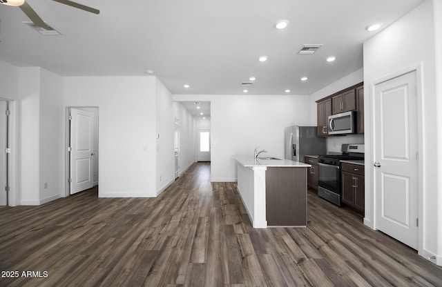 24593 W St Catherine Ave, Buckeye, AZ 85326 - kitchen featuring visible vents, dark brown cabinetry, dark wood-type flooring, a ceiling fan, and stainless steel appliances