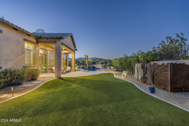 view of front of home featuring solar panels, a patio, and a mountain view