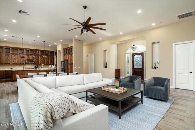 living room featuring light hardwood / wood-style flooring and ceiling fan