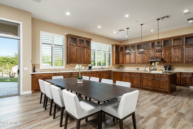 dining area featuring a wealth of natural light, light hardwood / wood-style flooring, and sink