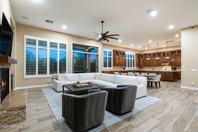 living room featuring ceiling fan and light hardwood / wood-style flooring