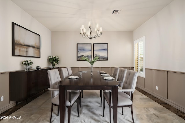 dining area with an inviting chandelier