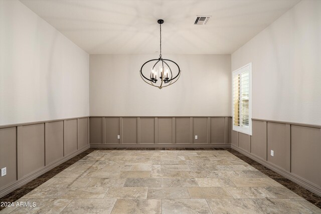 empty room with an inviting chandelier