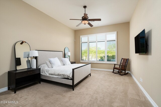 carpeted bedroom with vaulted ceiling and ceiling fan