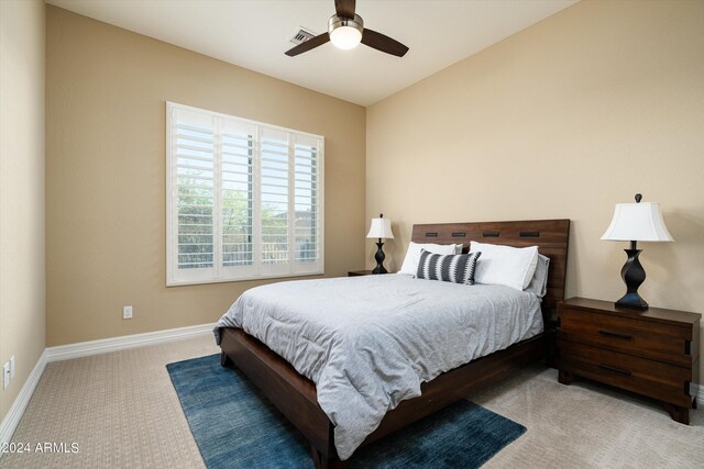 carpeted bedroom featuring lofted ceiling and ceiling fan