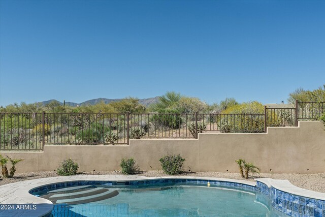 view of swimming pool featuring a mountain view