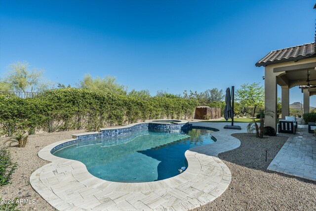 view of pool featuring a patio area and an in ground hot tub