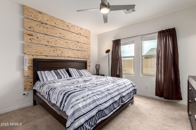 carpeted bedroom featuring visible vents, ceiling fan, and baseboards