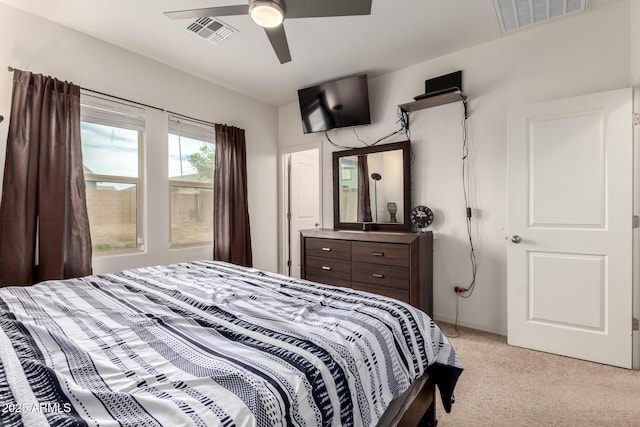 bedroom with visible vents, ceiling fan, and light carpet