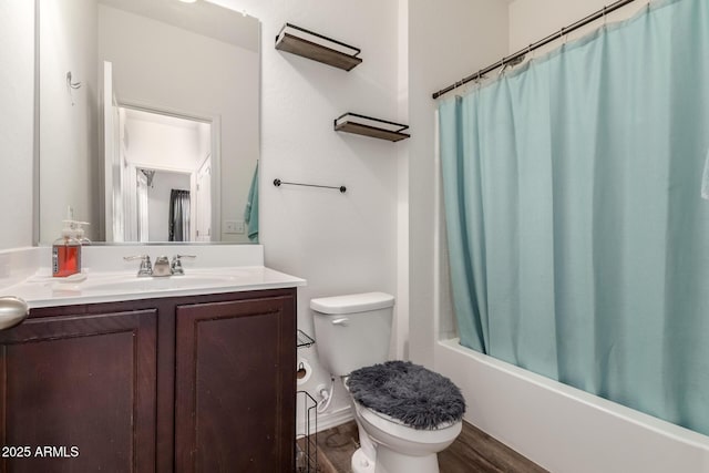 full bathroom featuring toilet, shower / bath combo with shower curtain, wood finished floors, and vanity