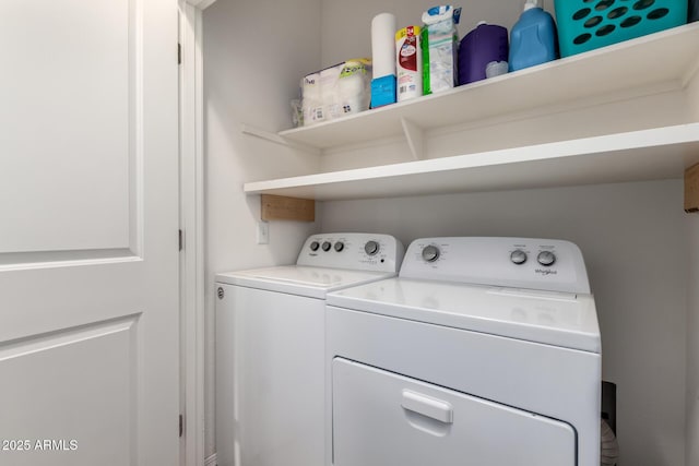 washroom featuring laundry area and washing machine and clothes dryer