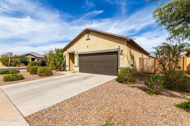 ranch-style home with driveway, a tile roof, an attached garage, fence, and stucco siding