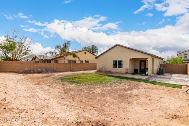 back of property featuring central AC unit, a patio area, a fenced backyard, and stucco siding