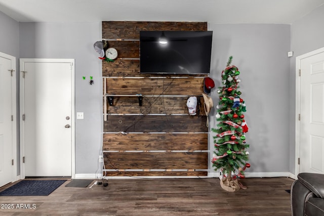 interior space featuring baseboards and wood finished floors