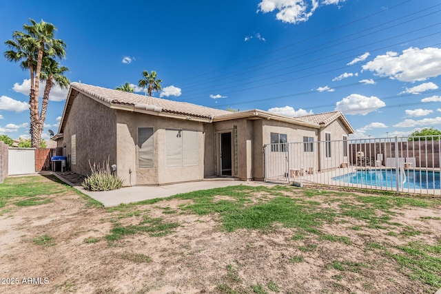 408 N Falcon Ct, Gilbert, AZ 85234 - rear view of house featuring fence, a fenced in pool, stucco siding, and a tiled roof
