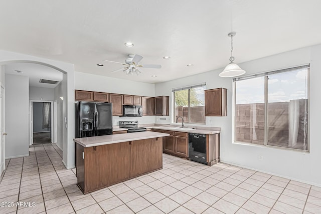 408 N Falcon Ct, Gilbert, AZ 85234 - kitchen featuring a kitchen island, visible vents, arched walkways, light countertops, and black appliances