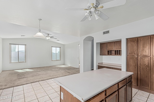 408 N Falcon Ct, Gilbert, AZ 85234 - kitchen with light carpet, open floor plan, ceiling fan, arched walkways, and vaulted ceiling