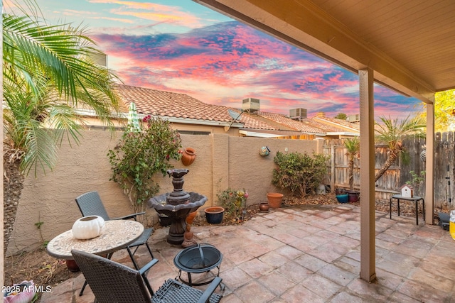 view of patio terrace at dusk