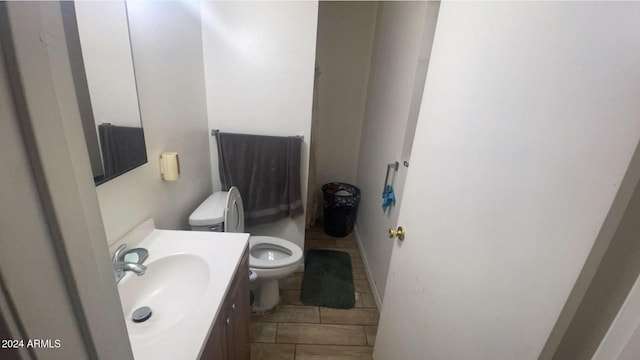 bathroom featuring tile patterned floors, vanity, and toilet