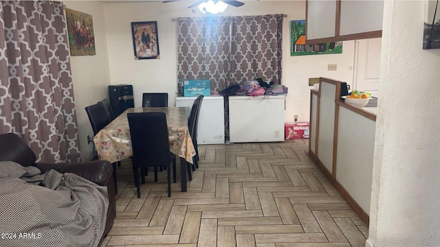 dining space featuring light parquet floors and ceiling fan