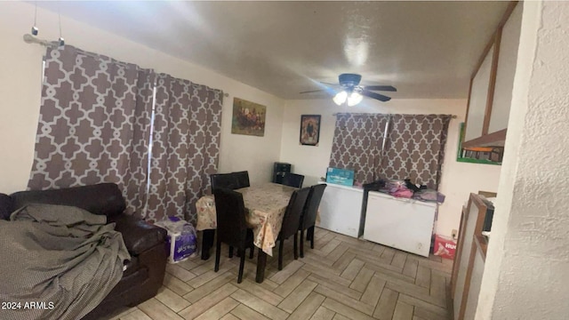 dining space with ceiling fan and light parquet floors