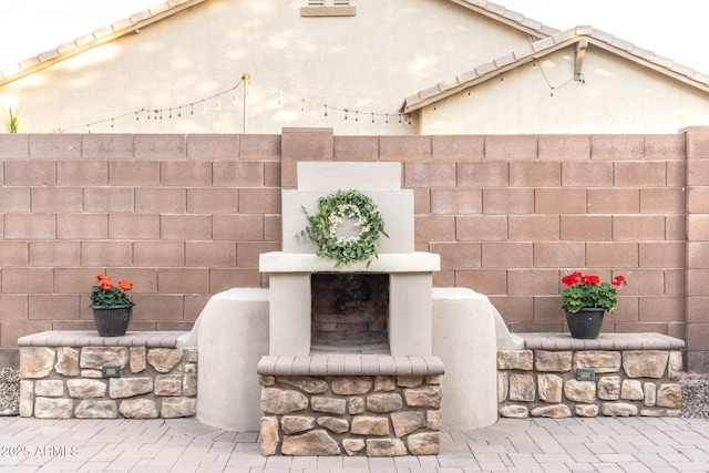 details featuring a fireplace and fence