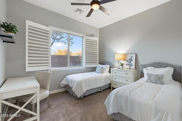 carpeted bedroom featuring ceiling fan, visible vents, and baseboards