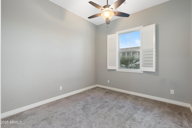 empty room featuring ceiling fan, carpet, and baseboards