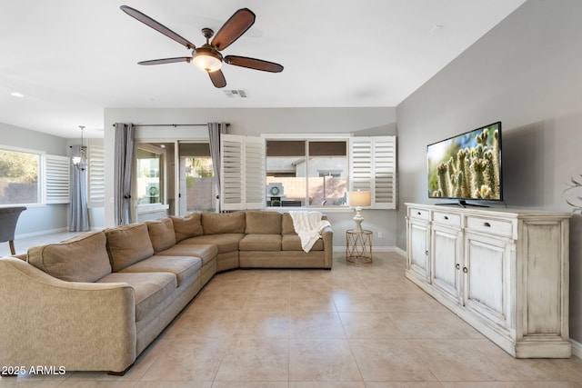 living area with ceiling fan, visible vents, a wealth of natural light, and light tile patterned flooring