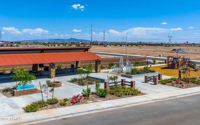 exterior space featuring a playground and a mountain view