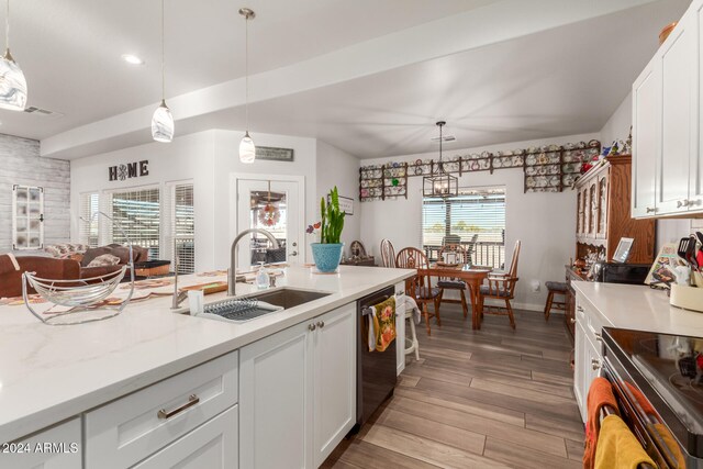 kitchen featuring dishwasher, sink, white cabinets, and plenty of natural light