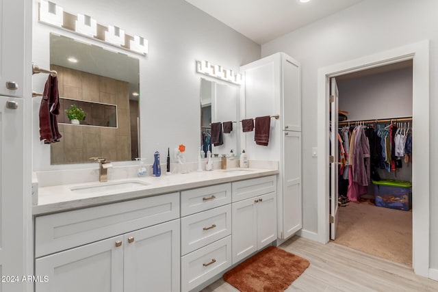 bathroom with vanity, wood-type flooring, and walk in shower