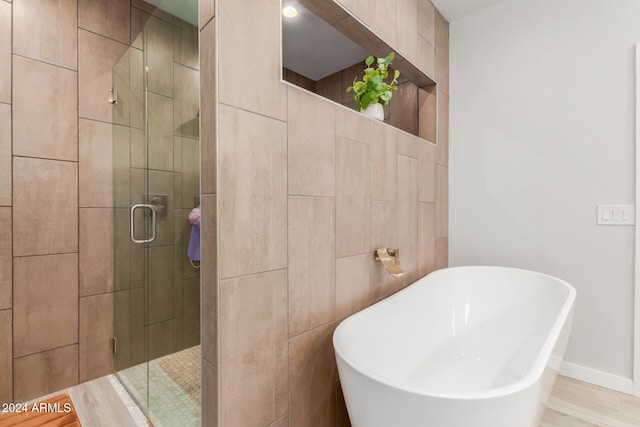 bathroom with plus walk in shower and wood-type flooring