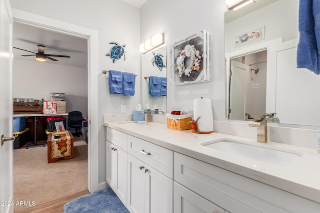 bathroom with a shower, hardwood / wood-style floors, vanity, and ceiling fan