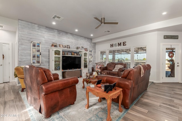 living room featuring ceiling fan and light hardwood / wood-style flooring