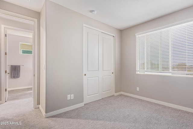 8026 S 6th Dr, Phoenix, AZ 85041 - unfurnished bedroom with a closet, baseboards, and carpet floors