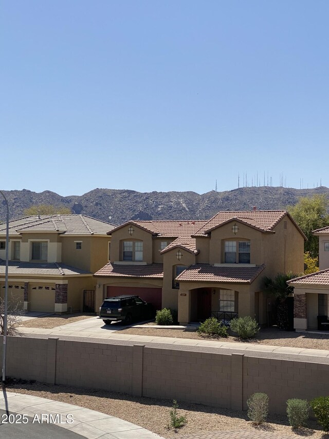 8026 S 6th Dr, Phoenix, AZ 85041 - view of front of home with stucco siding, a mountain view, an attached garage, and a tile roof
