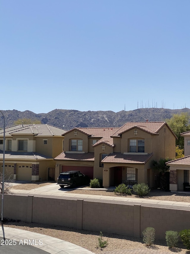 8026 S 6th Dr, Phoenix, AZ 85041 - view of front of home featuring an attached garage, a tiled roof, a mountain view, and stucco siding