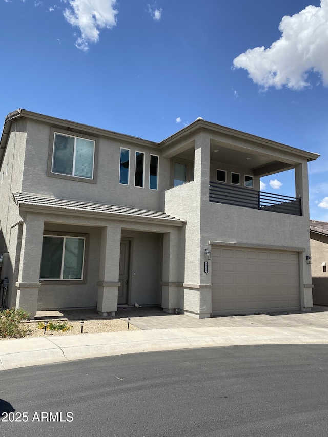 8026 S 6th Dr, Phoenix, AZ 85041 - view of front of property with an attached garage, stucco siding, and a balcony