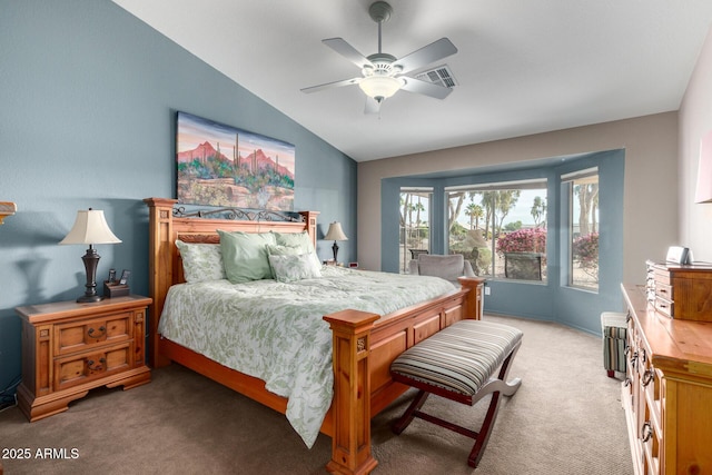 bedroom featuring vaulted ceiling, dark colored carpet, visible vents, and a ceiling fan