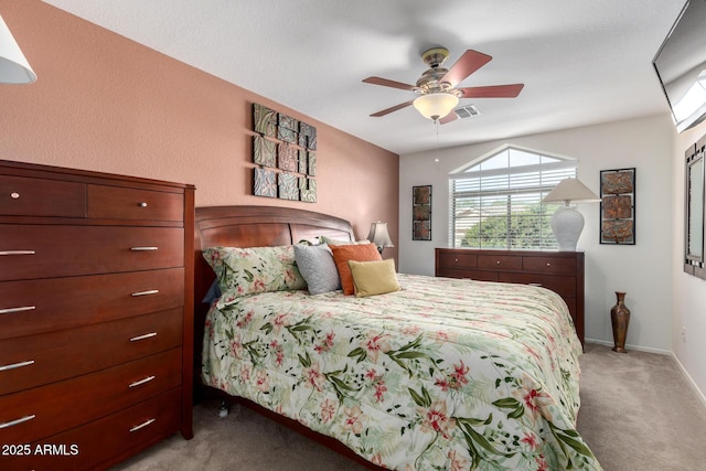 bedroom featuring light carpet, ceiling fan, and baseboards