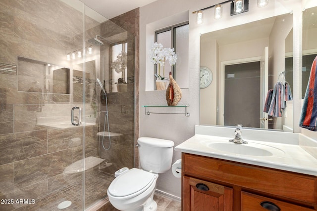 full bathroom with toilet, a shower stall, and vanity