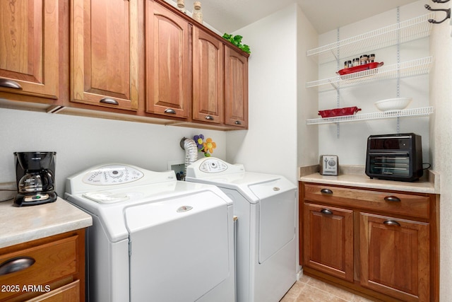 clothes washing area featuring cabinet space, light tile patterned floors, and independent washer and dryer