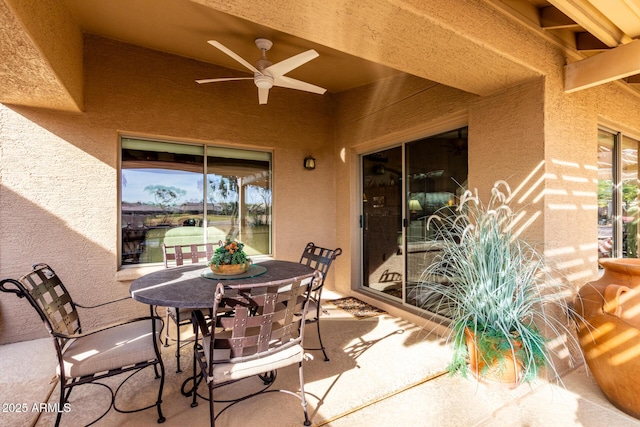 view of patio with outdoor dining space and a ceiling fan