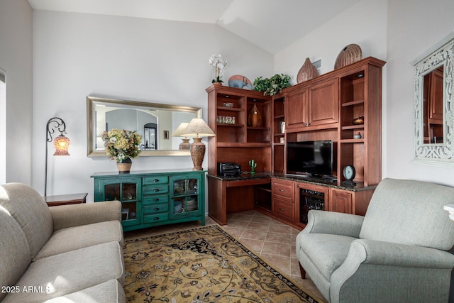 living area featuring lofted ceiling, light tile patterned flooring, and built in desk