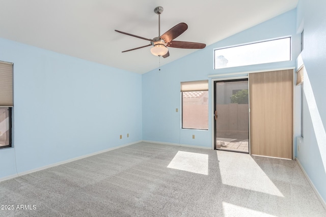 carpeted spare room featuring high vaulted ceiling and ceiling fan