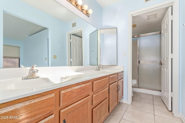 bathroom with tile patterned flooring, vanity, toilet, and walk in shower