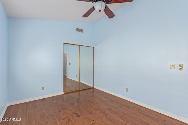 unfurnished room with hardwood / wood-style flooring, vaulted ceiling, and ceiling fan