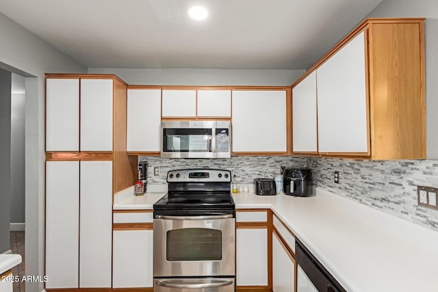 4741 N 85th Ave, Phoenix, AZ 85037 - kitchen with stainless steel appliances, light countertops, tasteful backsplash, and white cabinets